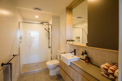 a bathroom with a toilet and a sink and a shower at The Beach Oasis ~ Dune in Kingscliff