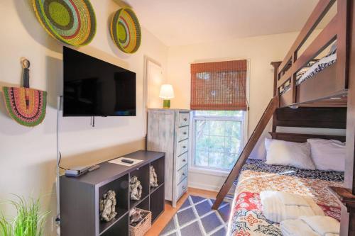 a bedroom with a bunk bed and a tv at Heron Hideaway in Folly Beach