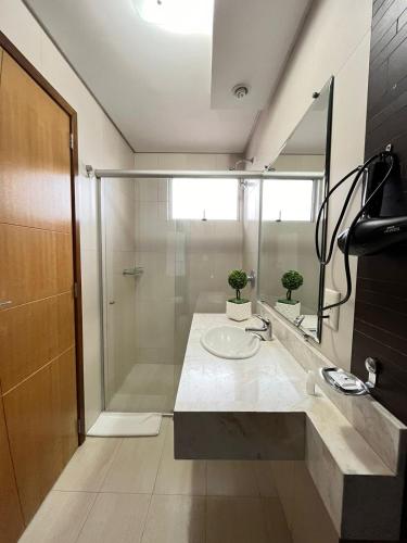 a bathroom with a sink and a shower at Regente Hotel in Pato Branco