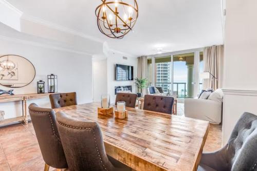 a dining room with a wooden table and chairs at Portofino Island P2-905 in Pensacola Beach