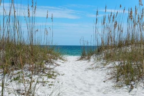 a sandy beach with the ocean in the background at Portofino Island P2-905 in Pensacola Beach