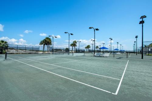 a tennis court with palm trees in the background at Portofino Island P2-905 in Pensacola Beach