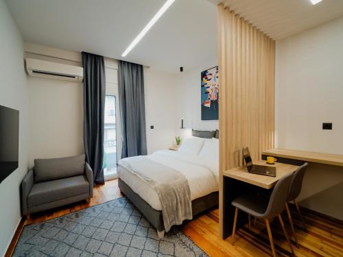 a bedroom with a bed and a desk and a chair at room 28-31 in Ioannina