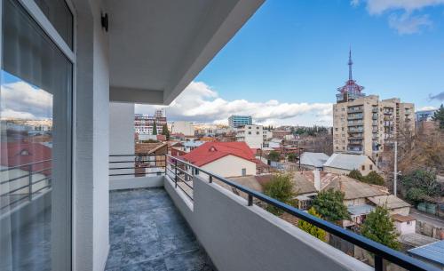 a balcony with a view of a city at Olympus Hotel By Umbrella in Tbilisi City