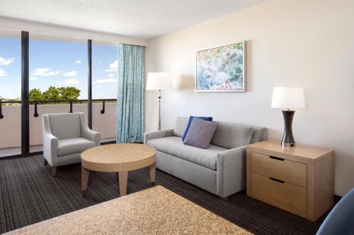 a living room with a couch and a chair at Embassy Suites by Hilton Tampa Airport Westshore in Tampa