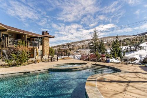 a swimming pool in front of a house at Shadowbrook 302 in Snowmass Village