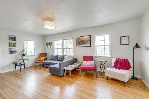a living room with a couch and chairs at Central Rapid City Home with Sunroom and Fireplace! in Rapid City