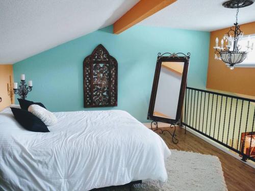 a bedroom with a white bed and a mirror at Lakefront Casita - Perfect for couples or families in Hot Springs