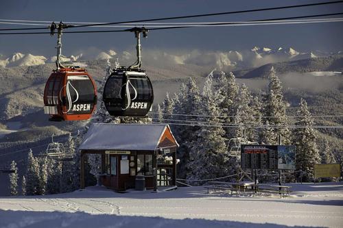 two gondolas flying over a snow covered mountain at Seasons Four 172 Two bedroom plus loft in Snowmass Village