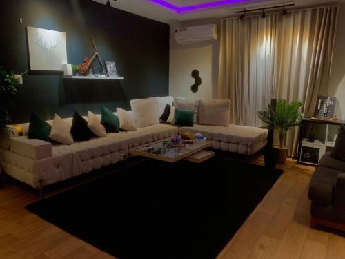 a living room with a couch and a table at شقه انيقه وموقع مميز in Dammam