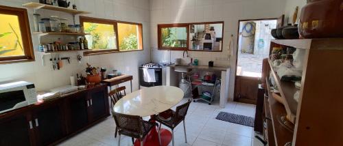 a kitchen with a table and a small table in it at Morada Cristal in Caraguatatuba
