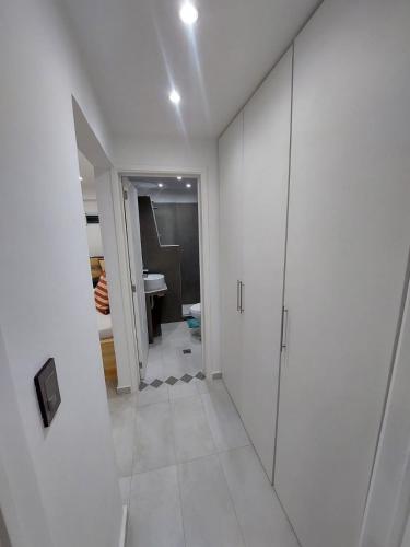 a white bathroom with a walk in shower and a toilet at Yaque Suite in El Yaque