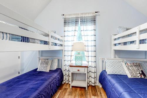 two beds in a room with blue and white bunk beds at The Bellevue in Lincoln City