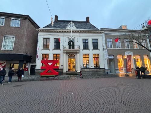 a white building with a red x in front of it at Hermanos City Appartement in Enschede