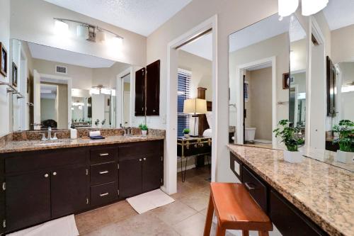 a bathroom with two sinks and two mirrors at Wanderlust - A Birdy Vacation Rental in San Antonio