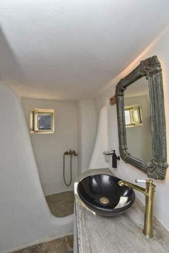a bathroom with a sink and a mirror at Zannis kelè Zannel seaside serenity in Kardiani