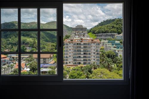 a view of a city from a window at Studios Exclusivos Xavishome Granja Brasil Itaipava in Itaipava