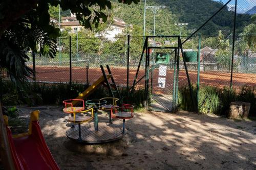 a playground with a slide and a swing set at Studios Exclusivos Xavishome Granja Brasil Itaipava in Itaipava