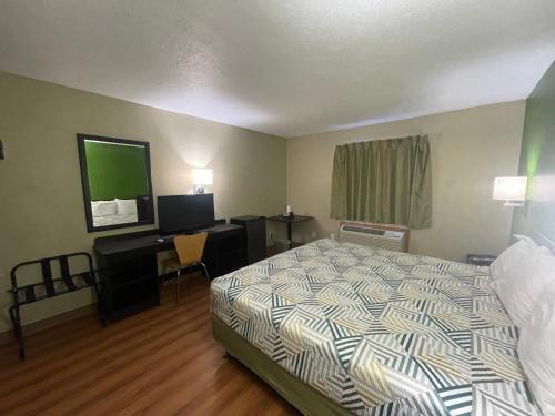 a hotel room with a bed and a desk at Dakota inn in Fargo