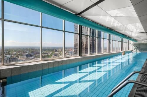 a swimming pool with a view of a city at Nook Melbourne Apartments : Jane Bell Lane - Melbourne CBD in Melbourne