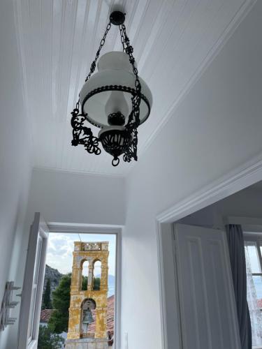 a chandelier hanging from a ceiling with a clock tower at Louisa’s View in Hydra
