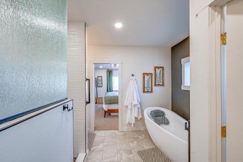 a bathroom with a bath tub and a sink at Stellar Craig Apartment - Walk to Restaurants! in Craig