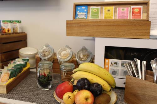 a table with a plate of fruit on a counter at Relais Villa Montedonzelli in Naples