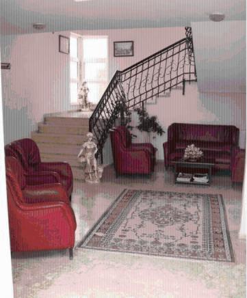 a living room with two chairs and a staircase at Samdan Hotel in Pamukkale
