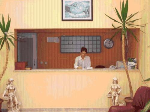 a woman sitting at a counter in an office at Samdan Hotel in Pamukkale