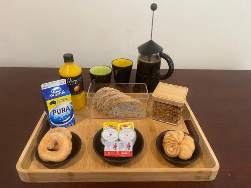 a tray with bread and other food on a table at Emerald Creek Cottages in Emerald
