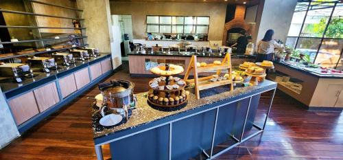 a bakery with a counter with a display of food at Stana Puri Gopa Hotel in Sanur