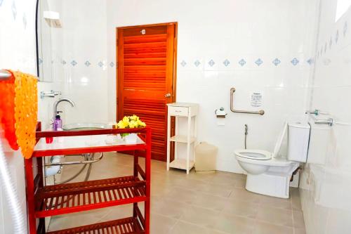 a bathroom with a toilet and a sink at Kingsacre in Nai Yang Beach