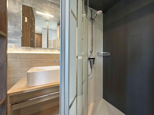 a bathroom with a shower and a sink at Holiday Village Seeblick - tiny house with lake view in Neunburg vorm Wald