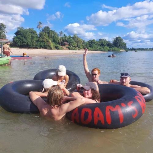 a group of people in the water on anlatable raft at Pol guesthouse in Muang Không