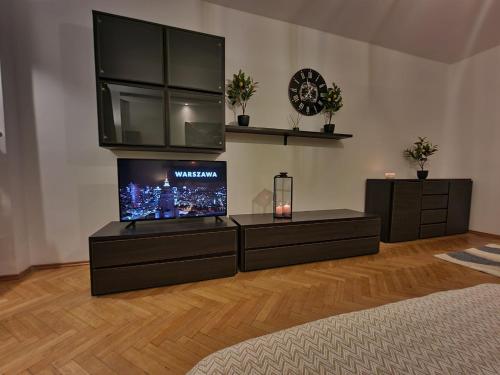 a living room with a flat screen tv on a stand at KS M Centrum in Warsaw