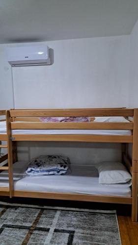 a bunk bed in a dorm room with a pillow at Apartmani Saraj in Sarajevo