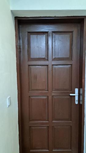 a wooden door in a room at Apartmani Saraj in Sarajevo