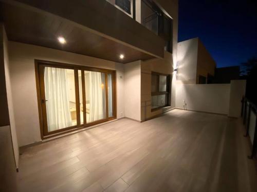 an empty room with a large window in a house at EN EL CENTRO DE LOBOS in Lobos