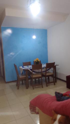 a dining room with a table and chairs at Hospedaria Meu Lar in Rio das Ostras