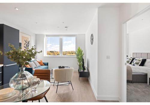 a white living room with a bed and a table at Beckenham Beauty: Modern 1-Bedroom Abode in Beckenham