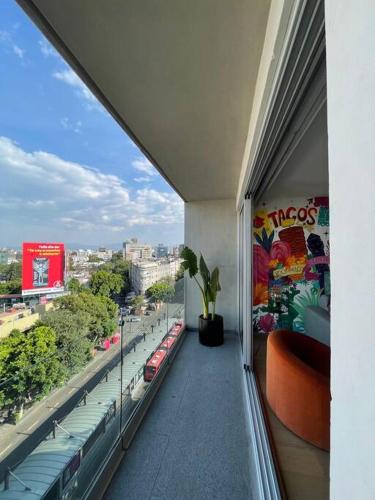 a balcony of a building with a view of a city at depto con alberca zona condesa in Mexico City