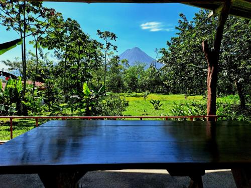 a wooden bench with a view of a mountain at Casas de Campo Las Pavitas Cottages "Red Frog" in Palma