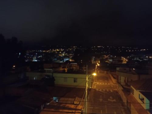 a city lit up at night with a street light at Habitación Encantadora in Otavalo
