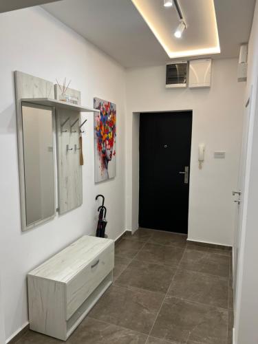 a room with a mirror and a cabinet and a door at The Great Square Luxury Apartments in Skopje