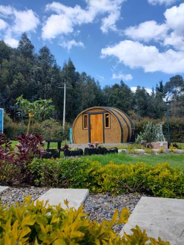 a tiny house in the middle of a garden at Aldea Fuquenense in Fúquene
