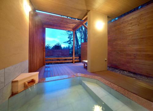 a swimming pool in the middle of a house at 湯音の森 in Kusatsu