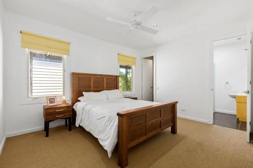 a bedroom with a large bed and a window at Lonnie Hideaway in Point Lonsdale