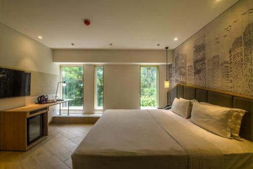 1 dormitorio con 1 cama grande y TV en Hotel Suncity Residency, en Bombay