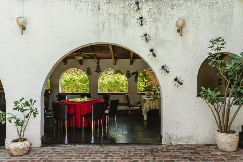 a dining room with a red table and chairs at Jacaranda Lodge in Victoria Falls