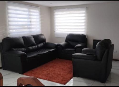 a living room with two chairs and a couch at Jade 1840 casa completa in San Carlos de Bariloche